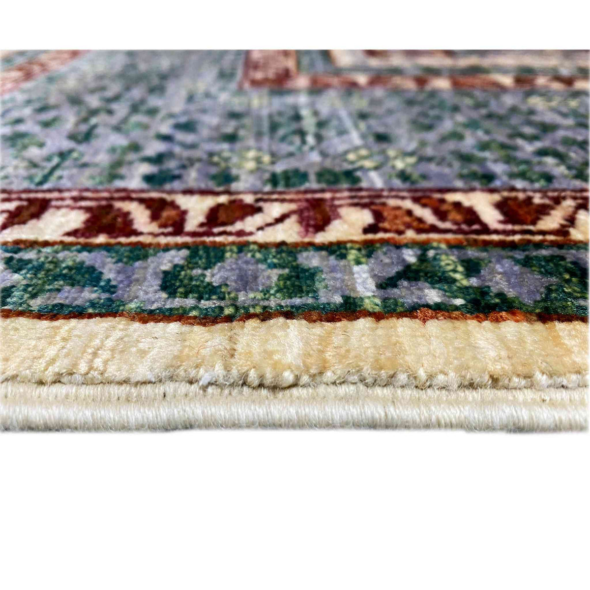 Rug edge with fringe and a stepped pattern in gray, green, and red