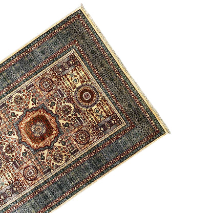Carpet corner with circular ornaments, dense pattern, and decorative border