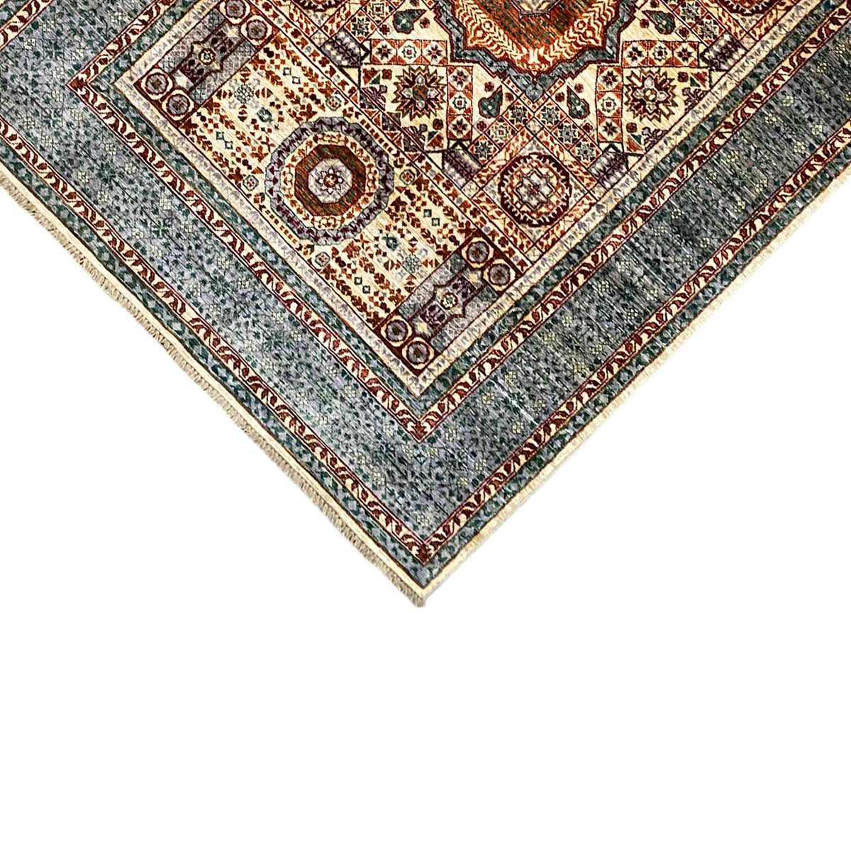 Carpet corner with a geometric border, surrounding trim, and fine fringes
