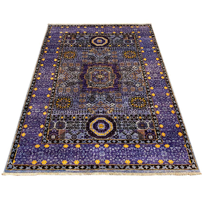 Rug with a blue ground and floral and geometric ornaments in the central area