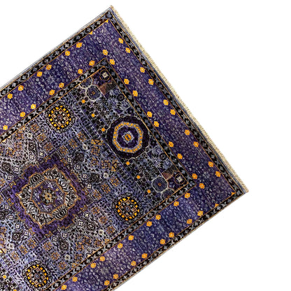 Carpet corner with an ornamental border, blue-purple background, and small yellow diamonds