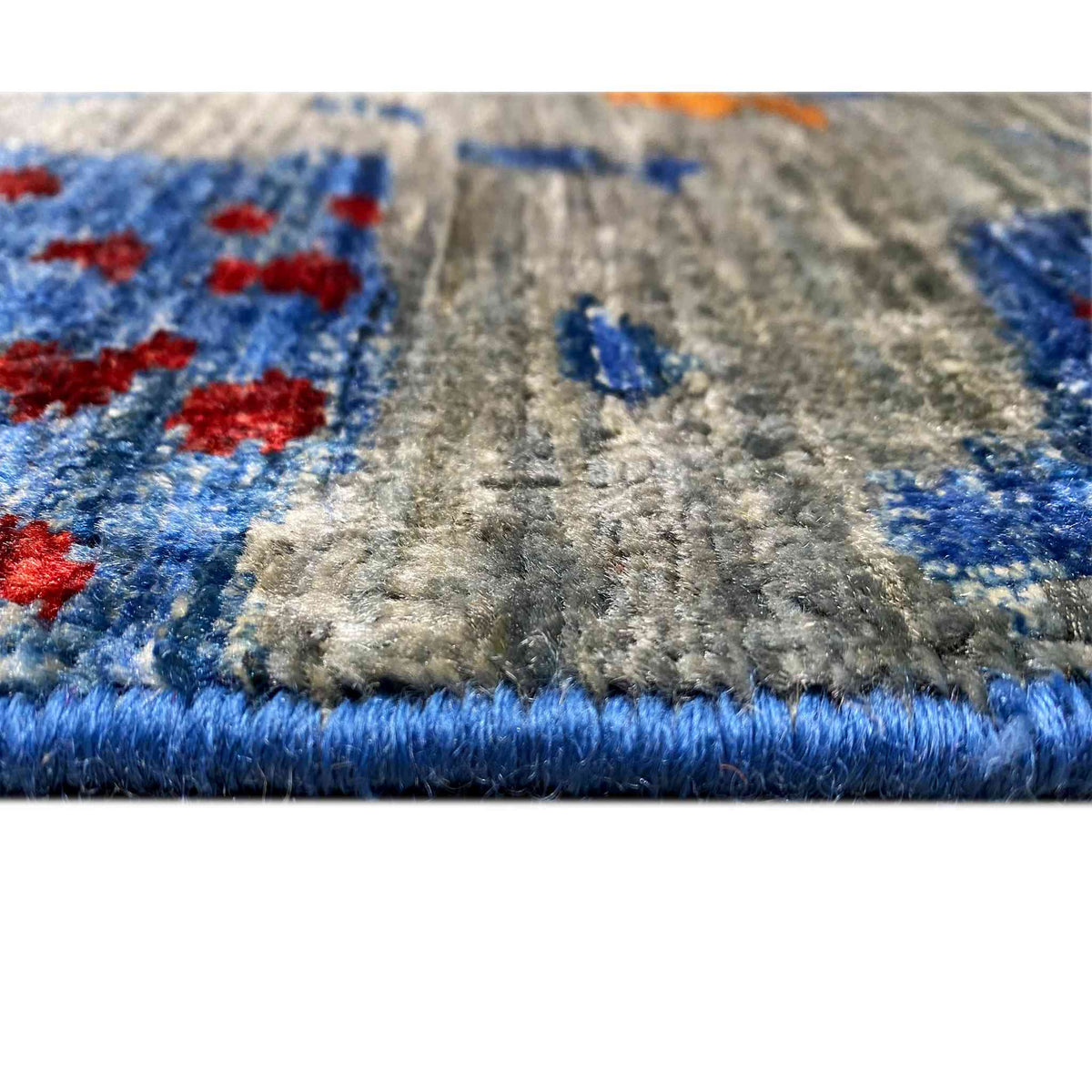 Hand-knotted Mamluk rug close-up at the edge: pile and fringes in blue and gray