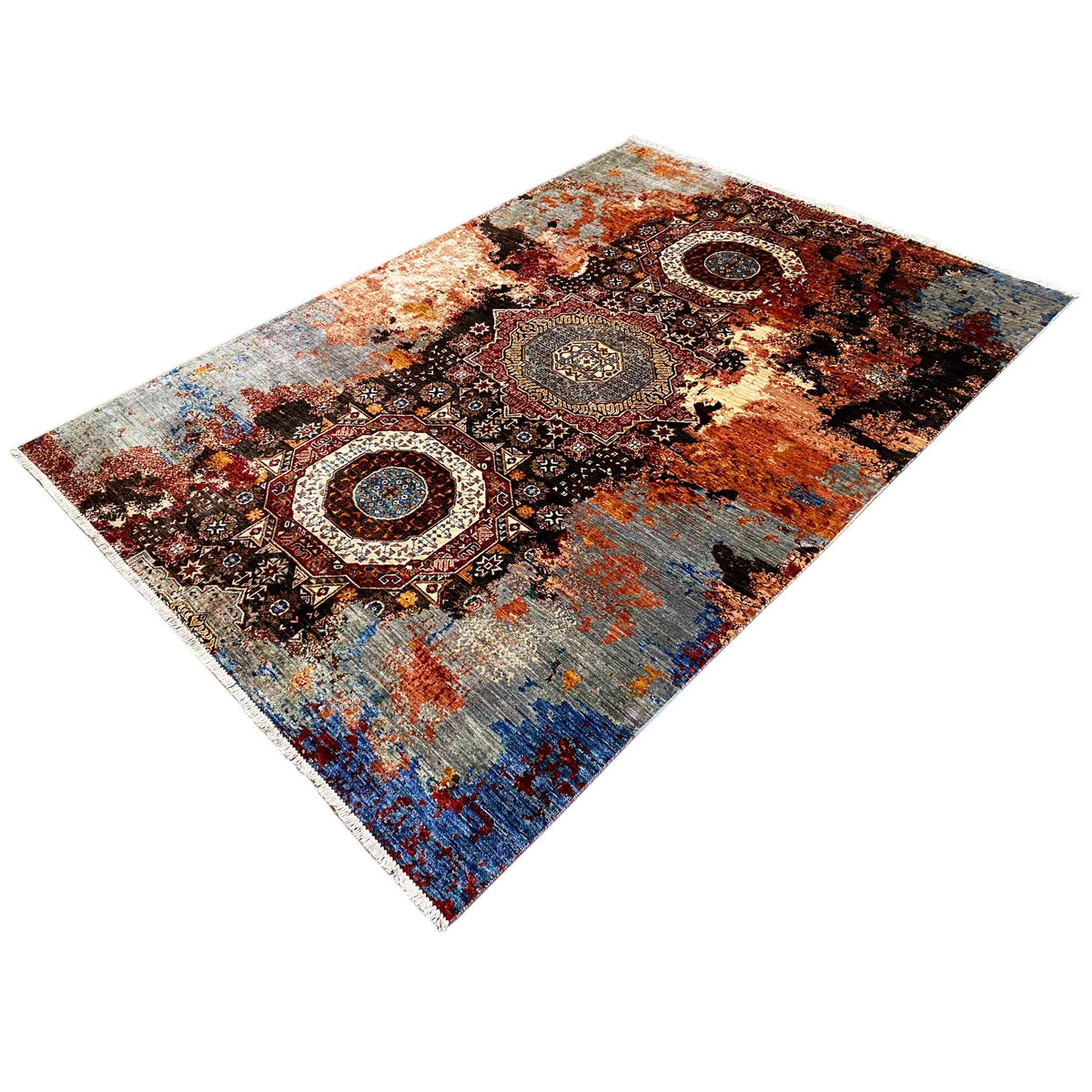 Mamluk rug at an angle with a medallion motif and areas of brown and blue color