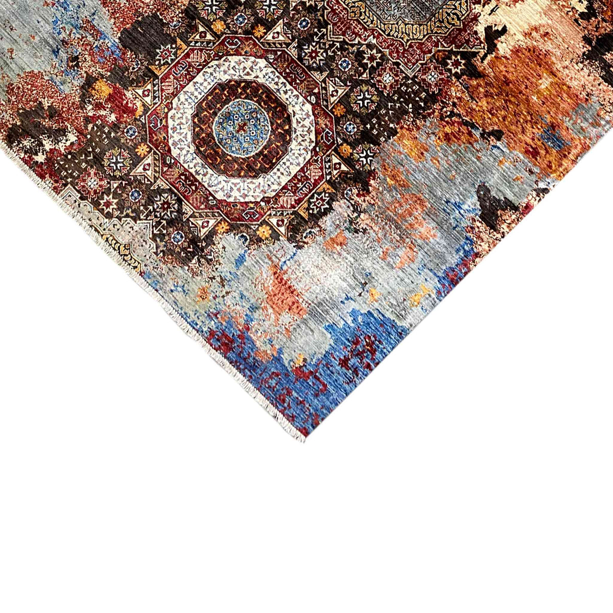 Mamluk rug detail at the corner with a medallion and mottled blue and orange appearance