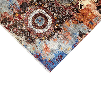 Mamluk rug detail at the corner with a medallion and mottled blue and orange appearance