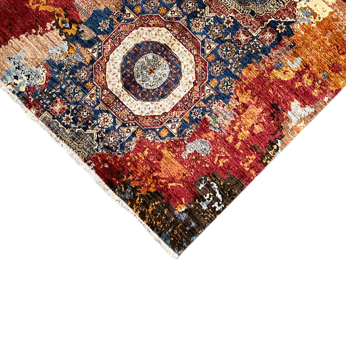 Hand-knotted Mamluk carpet corner with finished edge and colorful ornaments, close-up.