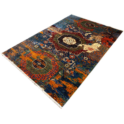 Hand-knotted Mamluk rug positioned at an angle, decorative ornamental pattern in blue and orange