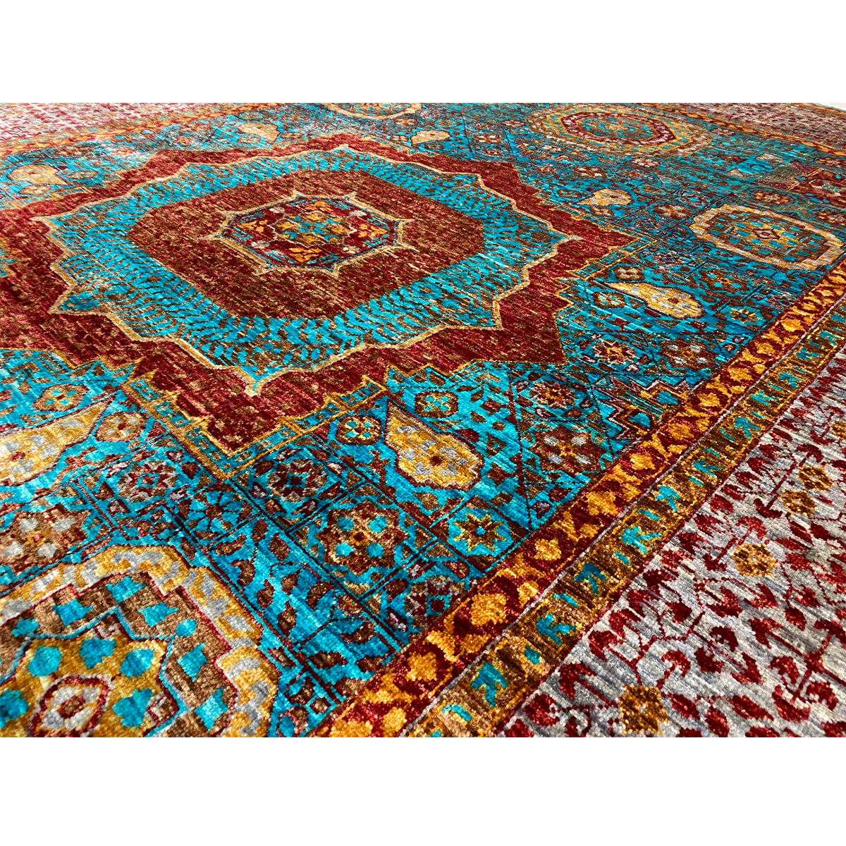 Hand-knotted rug, close-up: multicolored ornaments and fine weave structure