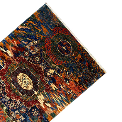 Mamluk rug with diagonal, bold ornamental fields and medallions, bordered all around.