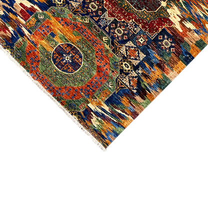 Mamluk carpet corner detail with colorful motifs and a short fringe border along the edge.