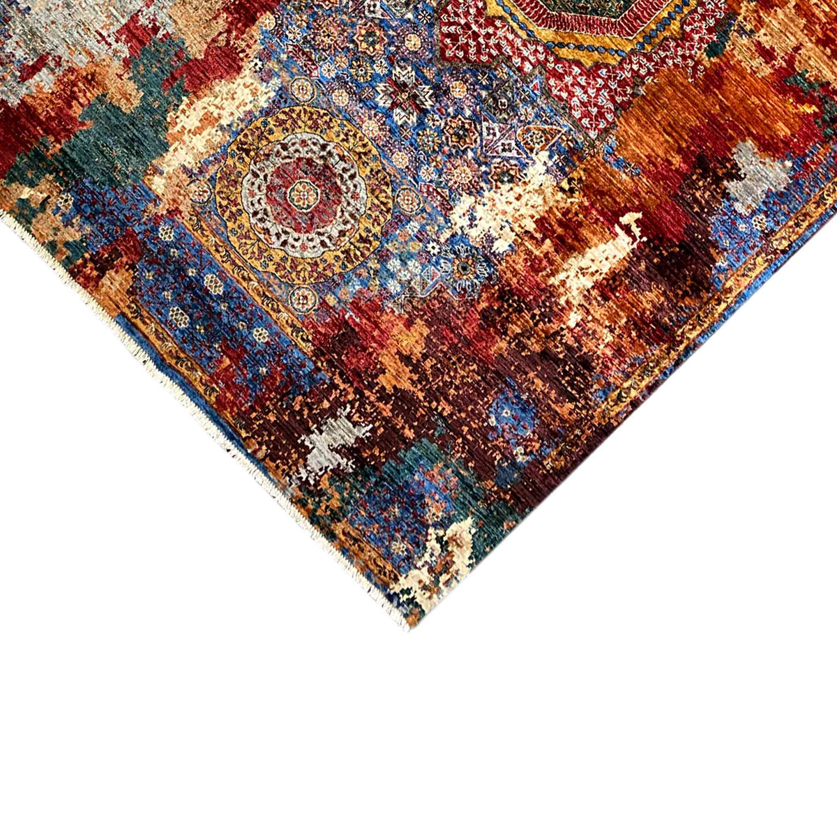 Close-up of rug edge: medallion pattern in blue, red, and cream with a cropped edge