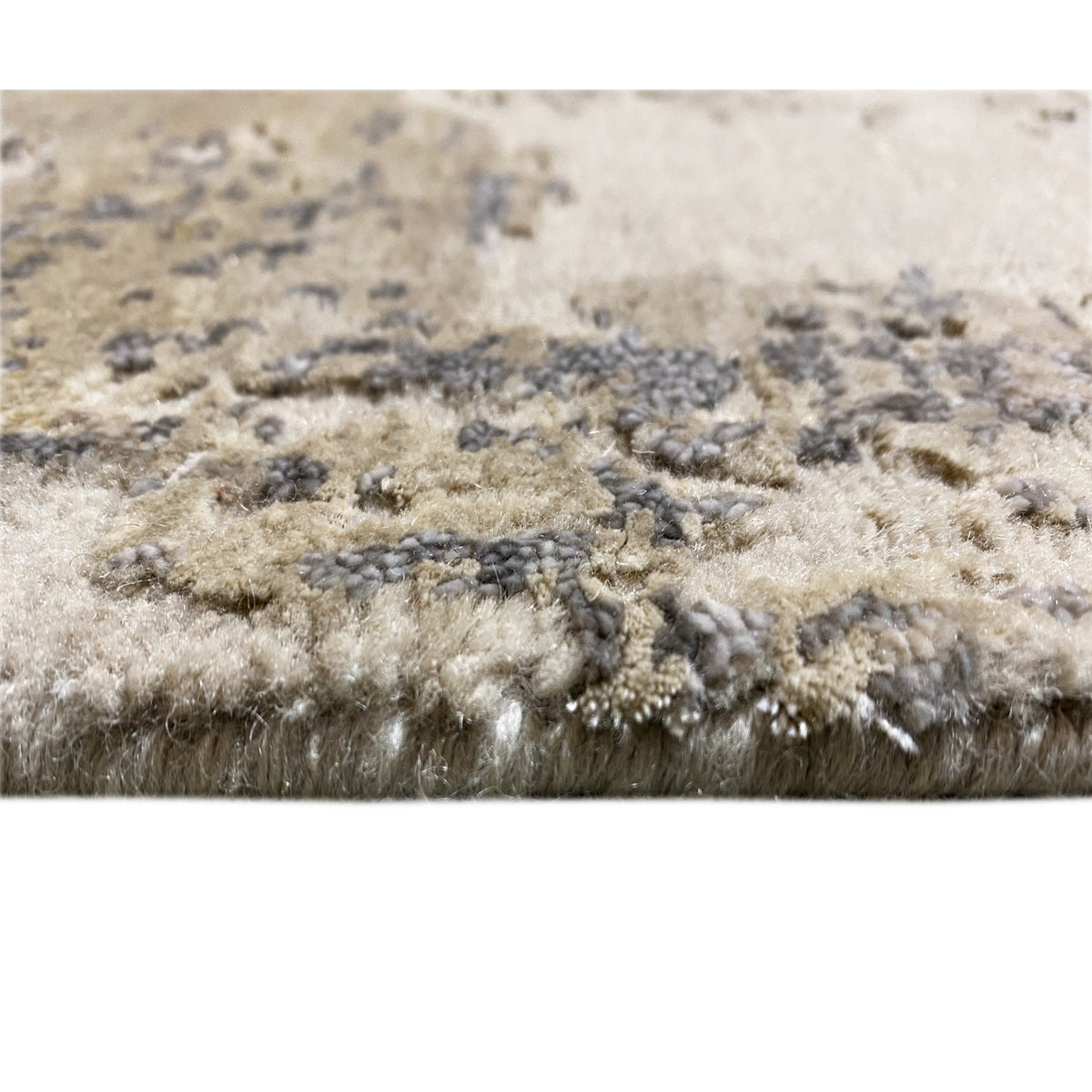Close-up of the carpet surface: beige pile with gray-blue accents and yellow sections