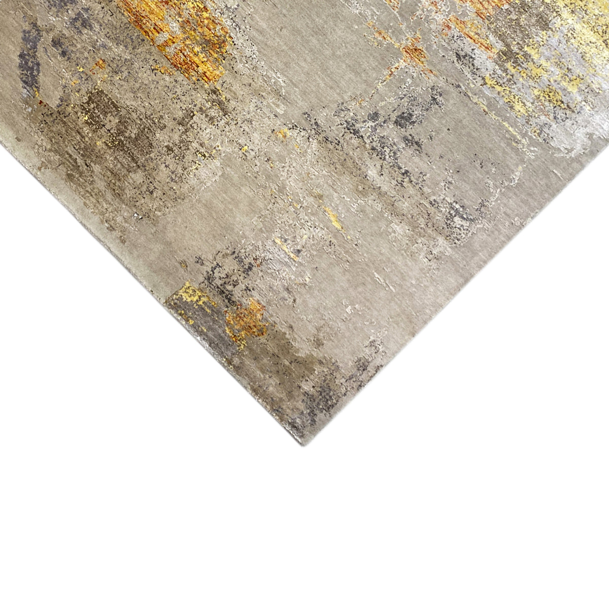 Close-up of a modern rug: beige abstract design with gray and yellow color accents