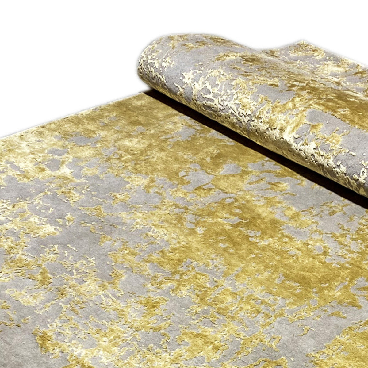 Modern rug (311x200 cm), partially rolled: gray and gold, heavily patterned surface