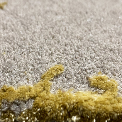 Rug detail: gray high-pile with irregular gold-colored accent areas