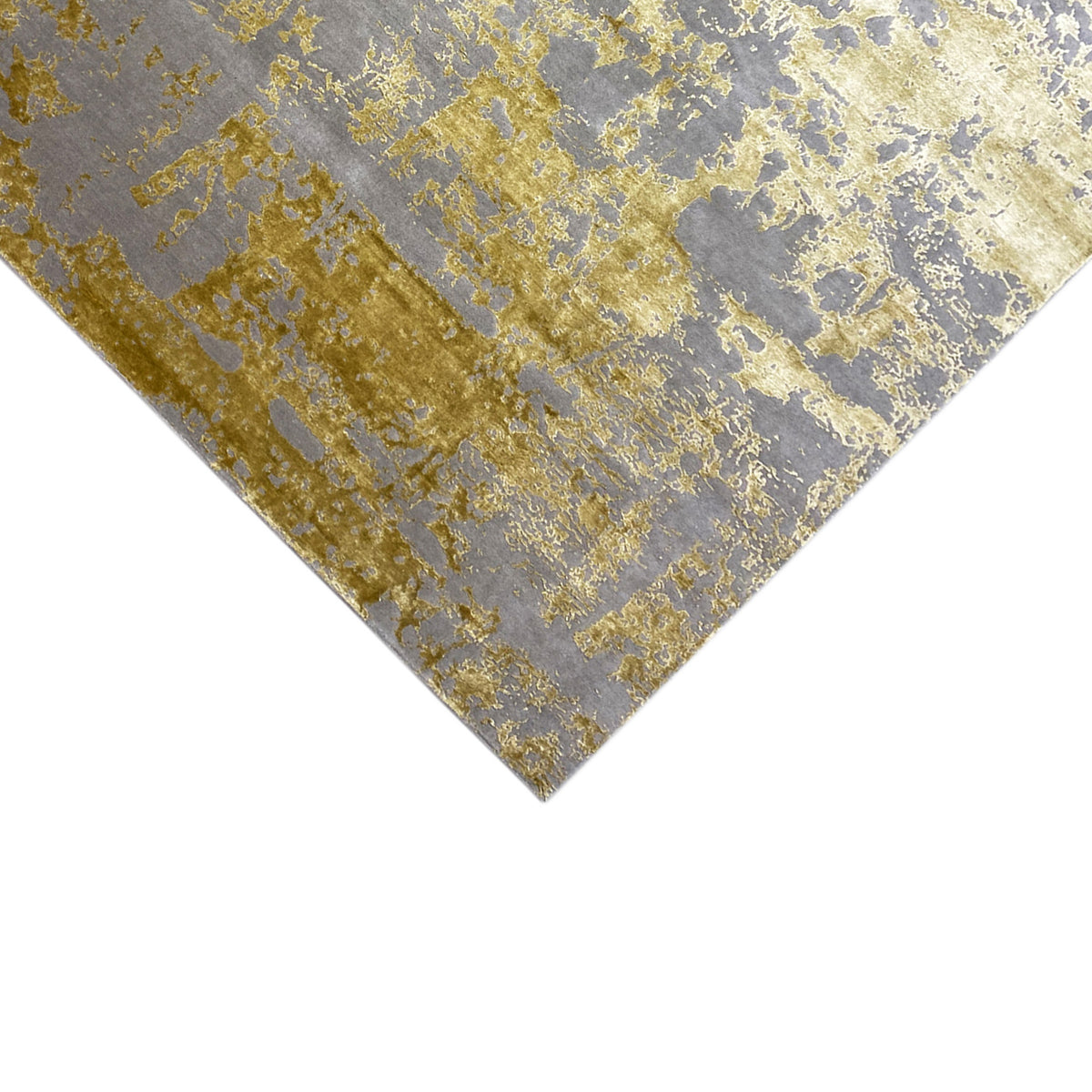 Rug detail, diagonal: gray-blue and gold speckled pattern with a vintage texture.