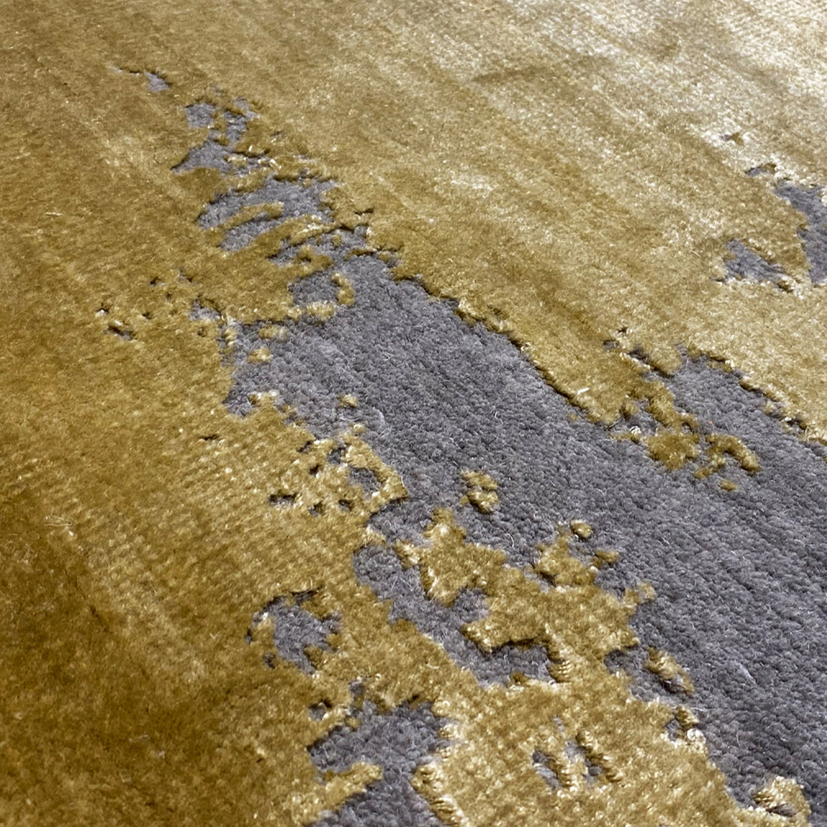 Close-up: Modern rug with yellow areas and blue-gray patterned sections
