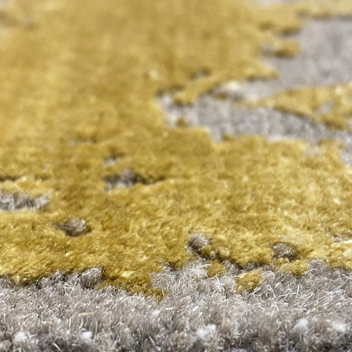Short-pile rug in mustard and gray tones, with irregular spots