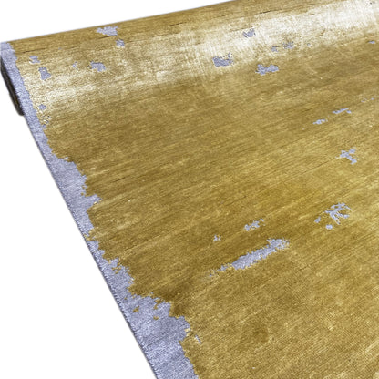 Corner view: modern mustard carpet with light blue ornaments and a gray border