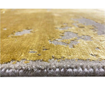 Close-up at the edge: Modern rug with a yellow area and gray pile