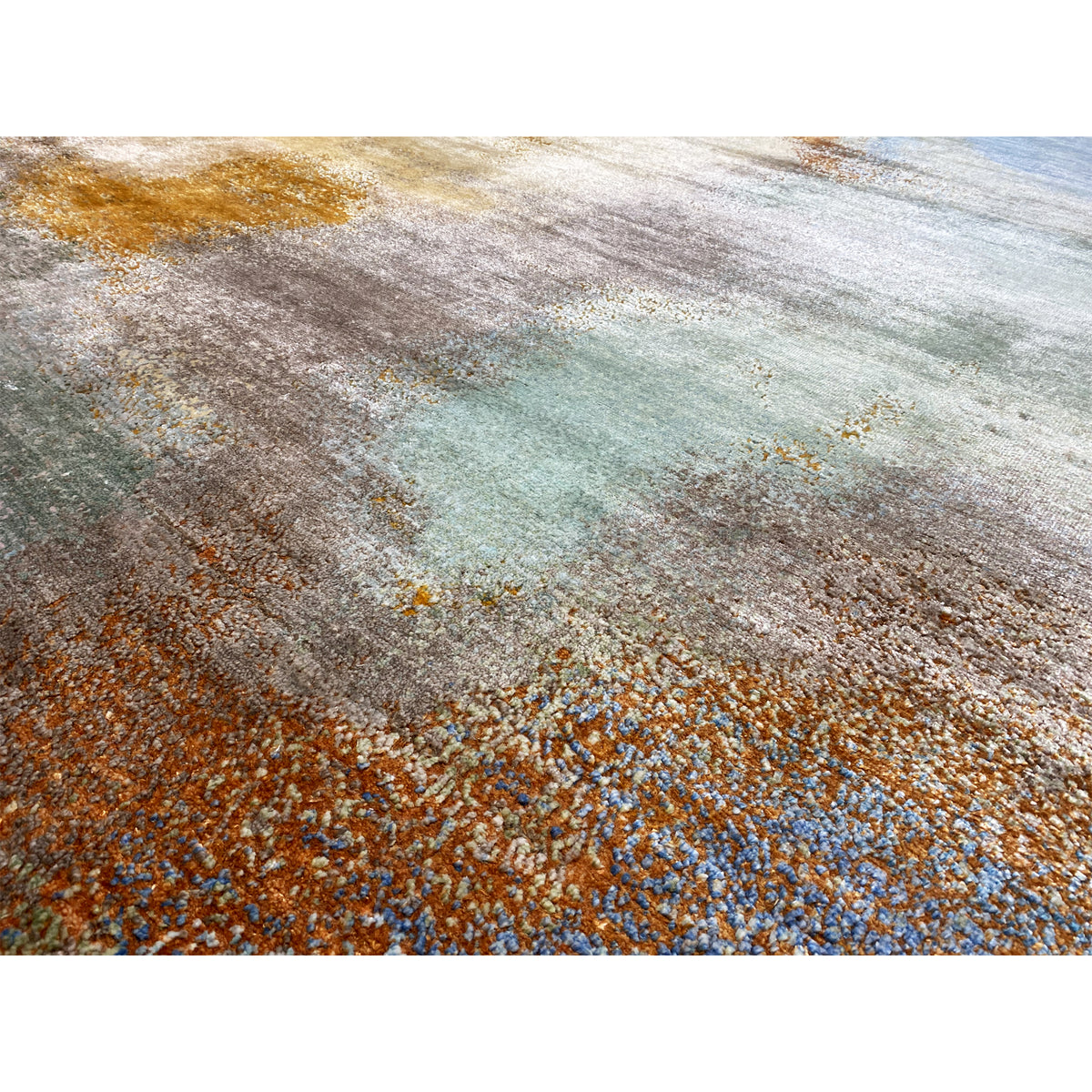 Modern rug 312x209 cm detail shot: textured pile in blue, orange, and beige