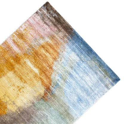 Modern rug 312x209 cm, photographed at an angle: abstract pattern in gold, blue, and gray