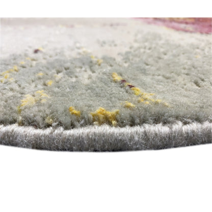 Rug border in the center of the pile, light gray with yellowish accents in the abstract pattern