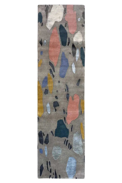 Rectangular terrazzo rug with an abstract pattern on a light gray background