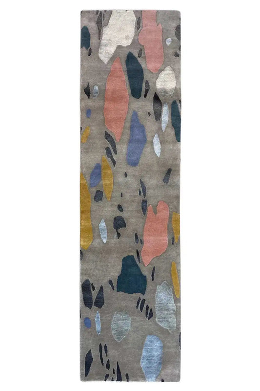 Rectangular terrazzo rug with an abstract pattern on a light gray background