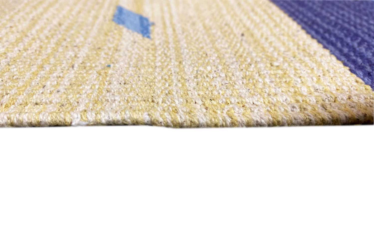 Close-up of the kilim runner rug: light woven surface with edge stripes