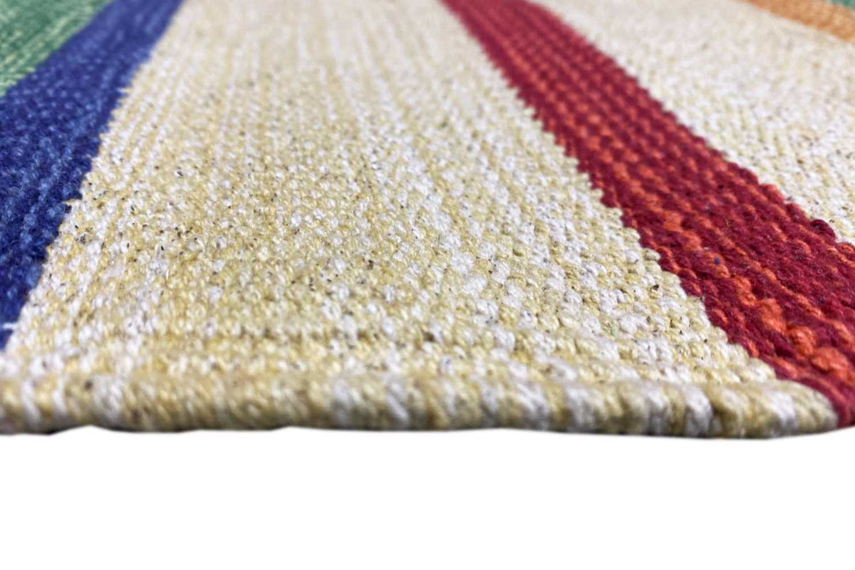 Close-up of the Samak kilim rug: woven texture with colorful stripes, pile visible