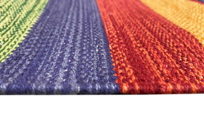 Carpet pile in detail: blue and red yarn with colorful woven stripes