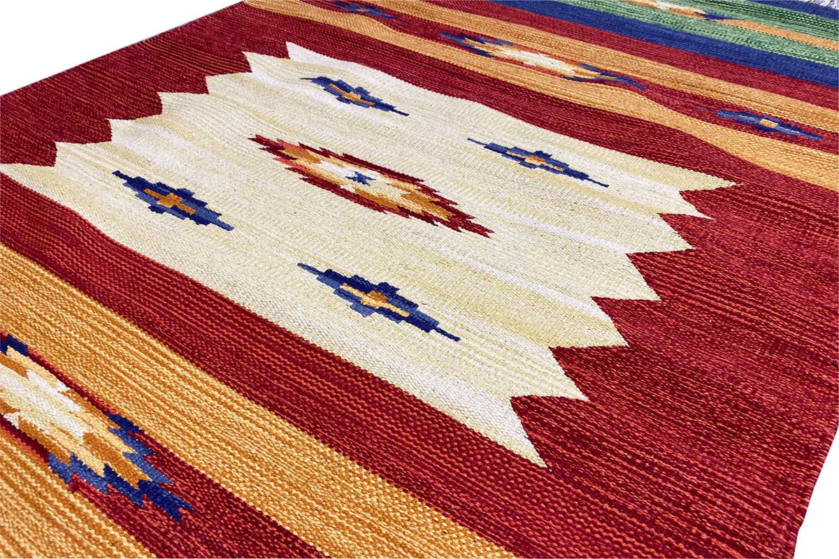 Kilim rug with a light central motif, reddish-brown borders, and colorful stripes