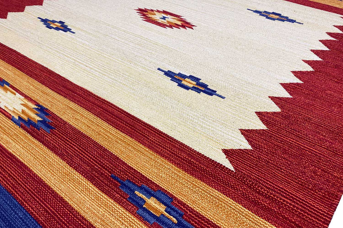 Kilim rug with a geometric pattern in cream, red, blue, and orange, with a narrow border