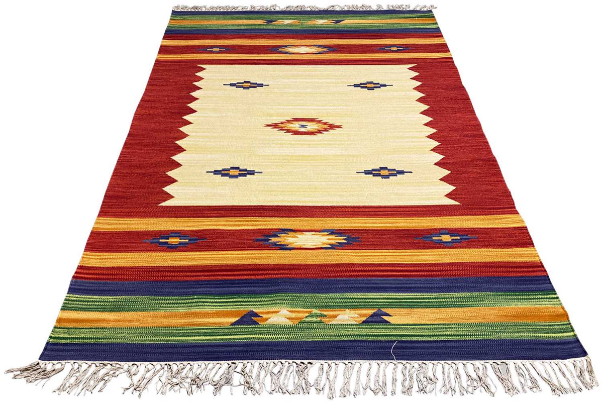 Kelim rug, shown at an angle: red and beige base with squares, stripes, and fringes