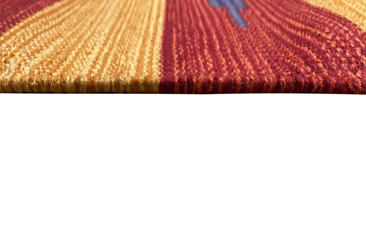 Close-up of the carpet edge: red and ochre fringe and woven fiber texture