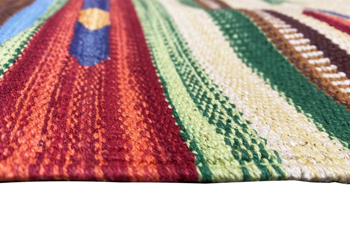 Close-up of a kilim rug: colorful woven texture with zigzag and striped patterns.