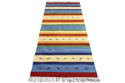 Modern kilim rug, tall portrait format with stripes in blue, beige, and red; fringes all around.