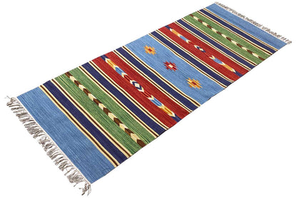 Blue kilim rug with multicolored stripes, geometric patterns, and fringes