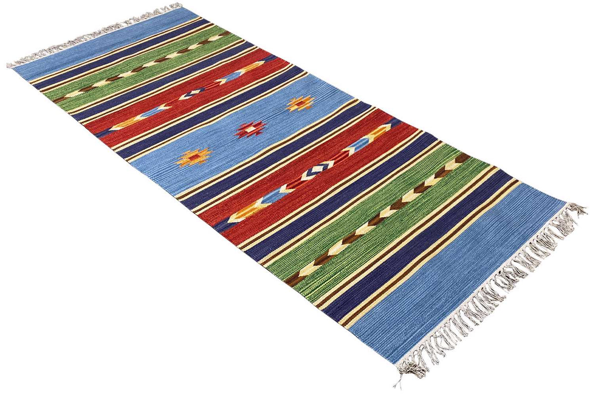 Blue kilim rug with stripes, red and green ornaments, and frayed edges