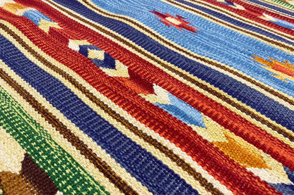 Kilim rug detail with multicolored stripes and geometric motifs