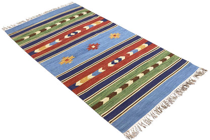 Kilim rug, diagonal: blue with colorful ornamental stripes and fringes along the edges
