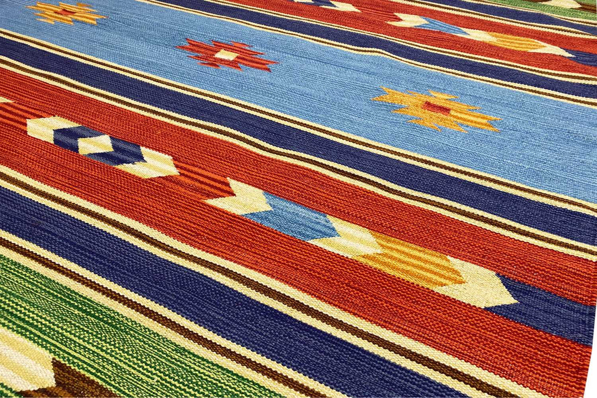 Modern kilim rug with a geometric pattern in blue, red, green, and beige