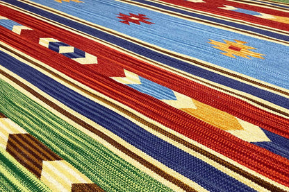 Kilim rug with blue, red, and green stripes and geometric motifs