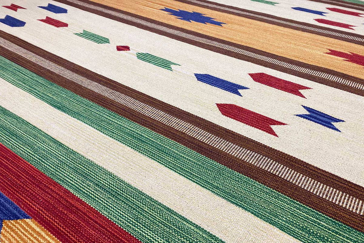 Close-up of a kilim rug: multicolored stripes and geometric ornaments in the design