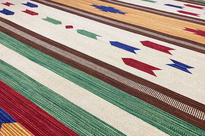 Close-up of a kilim rug: multicolored stripes and geometric ornaments in the design