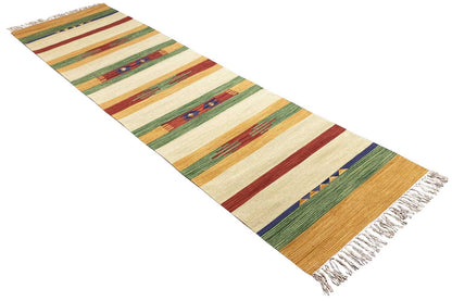 Kilim runner with a diagonal pattern, colored stripes, and fringe at one corner