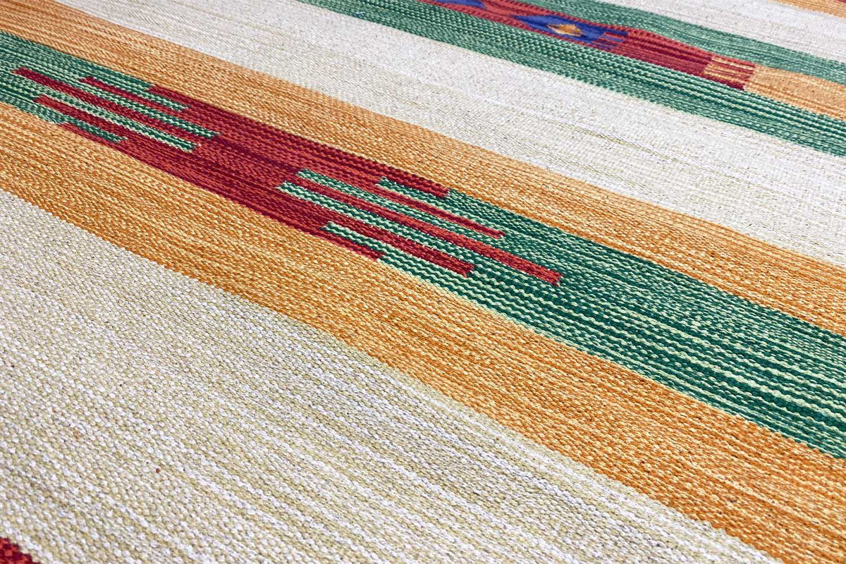 Close-up of the kilim runner: orange, green and red in a striped pattern