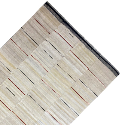 Kelim from a close-up perspective: beige background, black and red lines, dark blue border