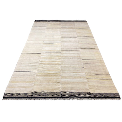 Persian kilim rug, cream-colored patchwork texture with a dark gray fringed border